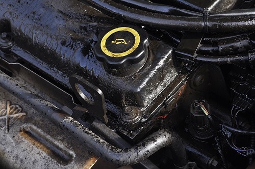 Why You Should Change Your Oil Regularly | Oil change by Columbia Auto Care & Car Wash in Columbia, MD. Image of a dirty car engine with oil.