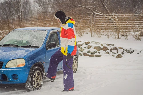 Keep Your Brakes Working This Winter. A man having brakes problem during a snowfall.